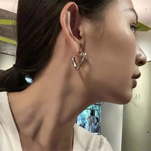 Silver geometric twisted hoop earrings for women with minimalist vintage design