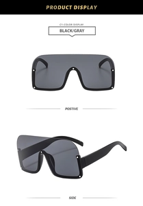 Detail view of black oversized semi-rimless sunglasses with silver rivet accents