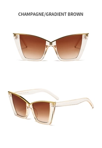 Close-up of champagne cat eye sunglasses with gradient brown lenses and gold frame edges