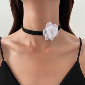 Elegant black velvet choker necklace featuring a large white fabric camellia flower