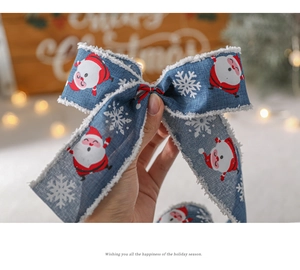 Close-up of blue Santa Claus and snowflake ribbon with white plush trim for gifts