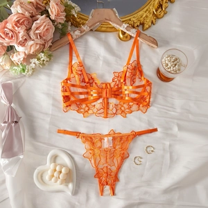 Detail of orange floral embroidery lace lingerie set with multi-strap hollow design