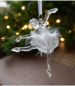Detail of crystal acrylic ballet dancer ornament with white feathers on a Christmas tree