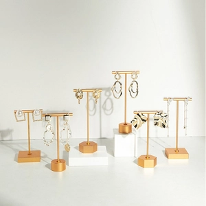 Set of 6 pairs of gold fashion earrings including pearls and geometric metal designs