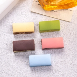 Detailed macro view of five colorful miniature resin chocolate cakes for DIY crafting