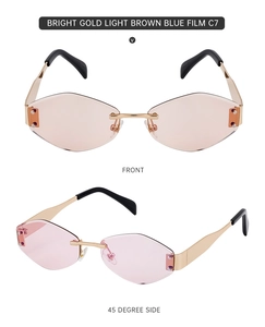 Detail view of rimless hexagon sunglasses with gold metal frame and brown lenses