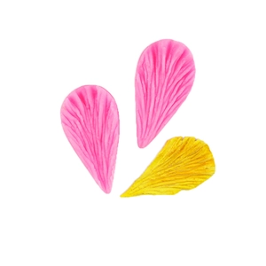 Macro detail of pink silicone petal texture mold with a yellow fondant leaf sample