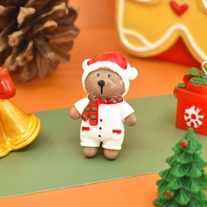 Detailed view of a hand-painted resin Christmas bear with festive holiday decor