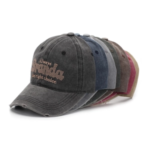 Detail of multi-color washed cotton baseball caps with vintage distressed brims
