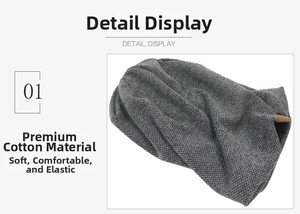 Detailed macro view of soft charcoal cotton fabric with textured waffle knit and leather tag
