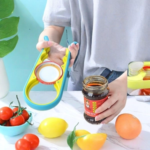 Multi-purpose 4-in-1 manual jar opener with non-slip grip on marble countertop