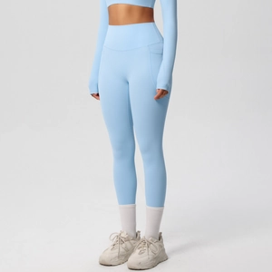 Close-up of light blue high-waisted yoga pants with functional side pockets and elastic fabric
