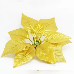 Detailed view of a glittering golden artificial poinsettia flower for Christmas tree decoration