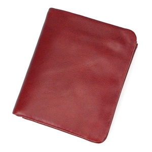 Detail showing deep red leather texture and fine stitching on the compact wallet