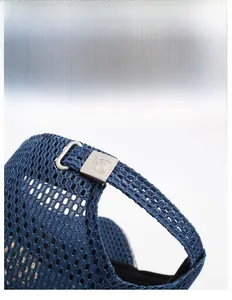 Close-up of mesh fabric and adjustable metal buckle on blue breathable sports cap