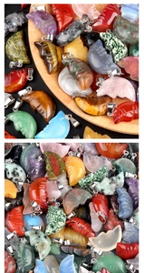 Macro detail of carved moon face pendants made from natural colorful gemstones