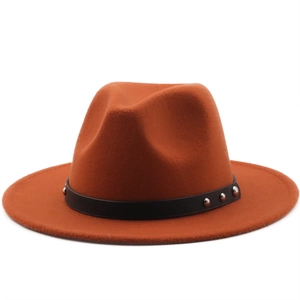 Close-up of caramel fedora hat with black leather band and silver metal rivets decoration