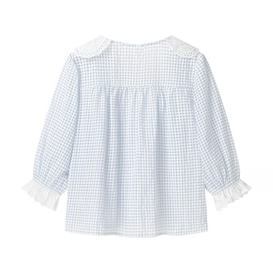 Detailed view of the white lace Peter Pan collar and light blue plaid cotton fabric