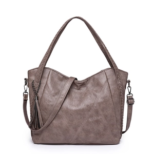 Large taupe PU leather tote bag with quilted stitching, tassel, and woven handles