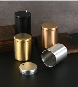 Detail of four brushed stainless steel toothpick holders in black, gold, and silver finishes