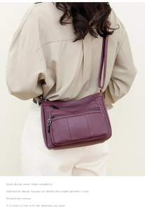 Detail of purple soft leather crossbody bag with multiple zippers and lychee texture