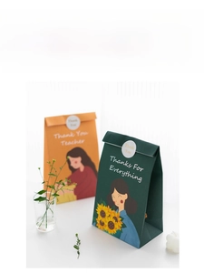 Detailed close-up of thank you teacher gift bags with floral illustrations and handle