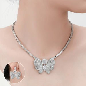 Detailed view of silver butterfly necklace and earrings set with sparkling zircon stones