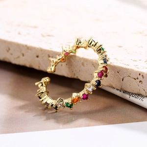 18K gold plated adjustable open ring with colorful zircon stones on stone background