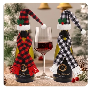 Close-up of festive plaid Christmas mini hats and scarves decorating wine bottles on a table