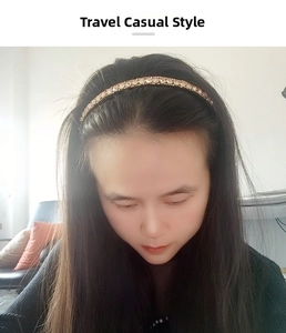Close-up of a slim baroque gold headband with sparkling crystals worn by a model