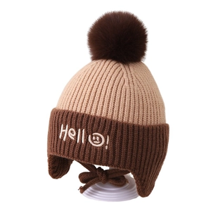 Winter knit hat for children with earflaps and fluffy pompom featuring a hello embroidery