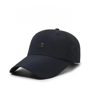 Detail of laser-cut ventilation holes and S embroidery on navy baseball cap