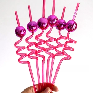 Close-up of six pink spiral party straws featuring shiny disco mirror ball decorations