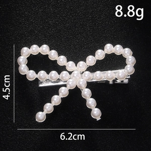 Detailed view of pearl bow hair clip with size measurements 6.2cm by 4.5cm and 8.8g weight