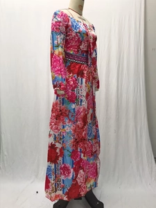 Detail of floral printed maxi dress showing fabric texture and waist decorative belt