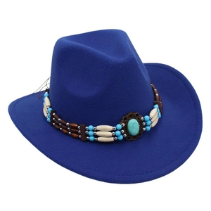 Close-up of ethnic cowboy hat band featuring turquoise beads and vintage bronze buckle
