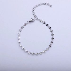 Close-up of silver steel bracelet with sunburst textured links and lobster clasp
