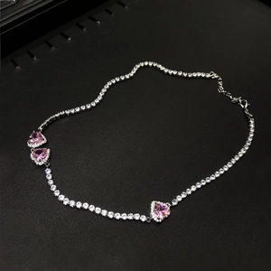 Detail of pink heart-shaped crystal necklace on tennis chain with sparkling zircons