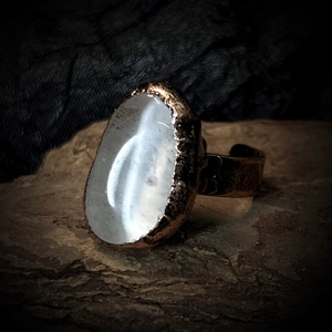 Macro shot of irregular white crystal stone on vintage bronze adjustable ring band