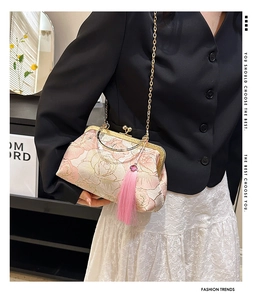 Detail of pink floral jacquard kiss-lock bag with gold chain and silk tassel