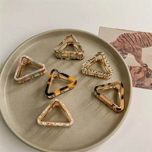 Set of six geometric acetate hair claws in triangle shapes with various patterns
