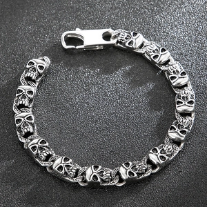 Macro detail of retro skull link bracelet in aged silver finish with spring clasp closure