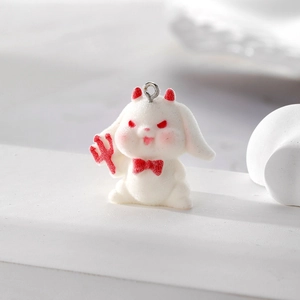 Macro view of white flocked devil bunny pendant with red horns and metallic loop