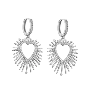 Detail of silver heart hoop earrings with spikes and pavé zircon stones on white background