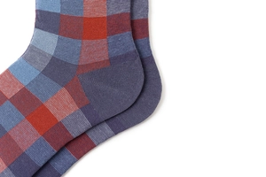 Close-up of men's cotton ankle socks featuring a classic red, blue and grey checkered pattern