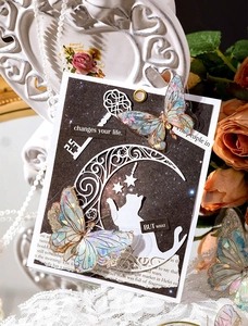 Detailed view of iridescent laser butterfly stickers and celestial motifs on vintage decor