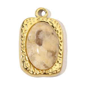 Detail of oval cream natural stone pendant with hammered gold-tone stainless steel frame