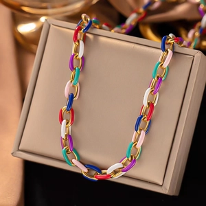 Colorful enamel titanium steel necklace with gold links on a beige jewelry box display