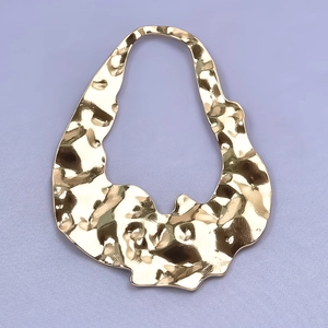 Detailed view of irregular 304 stainless steel gold pendant with hammered texture design