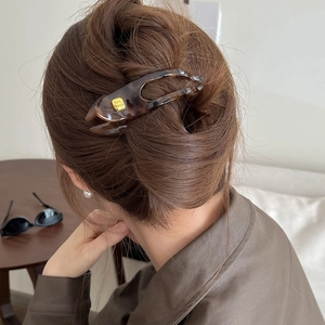 Brown tortoiseshell PC hair claw clip worn by a model for elegant back bun styling